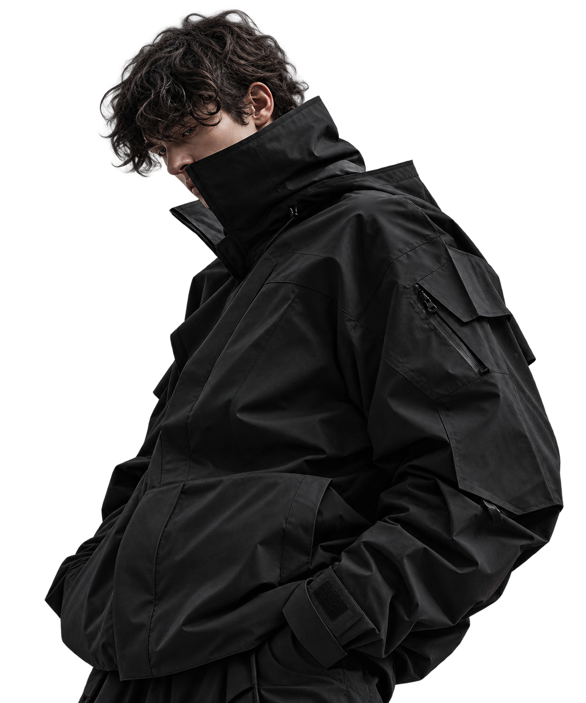 Curly-haired model in a sculptural black high-collar jacket